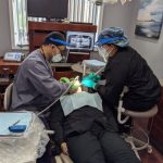 Dr. Nicholas Kouri - working on a patient